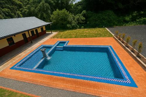 an overhead view of a swimming pool in front of a house at Inap Keranji Homestay With Pool in Kota Bharu