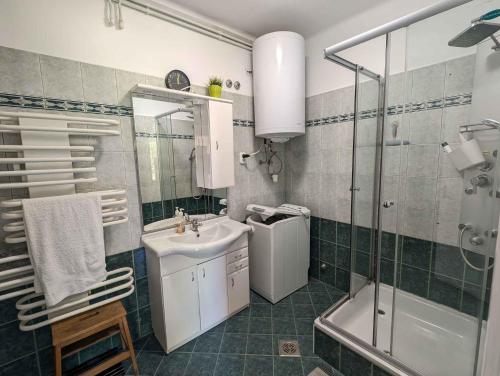 a bathroom with a sink and a toilet and a shower at Holiday home in Zamardi - Balaton 54796 in Zamárdi