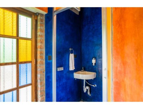 a bathroom with a sink and a blue wall at goSTOPS Pondicherry Near Auroville in Auroville