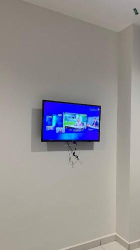 a flat screen tv hanging on a white wall at Melody Inn Hotel in Kluang