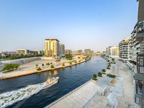a river in a city with a boat in it at Fantastic Rooftop Pool - Full Canal Views - Spacious 1 BDR Designed by Designer - 5 min walk from Space42 Arena in Abu Dhabi