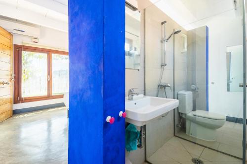 a bathroom with a white sink and a toilet at Can Pessal in Es Carritxo