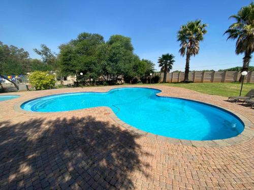 a small swimming pool in a brick yard at Be My Guest Hotel Conference in Sasolburg