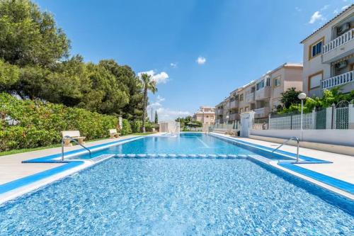 a swimming pool in the middle of a building at Ground floor apartment with terrace and pool in La Mata