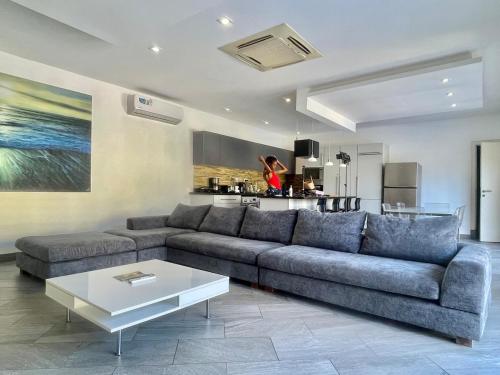 a living room with a couch and a table at Grand Amber Villa in Diani Beach