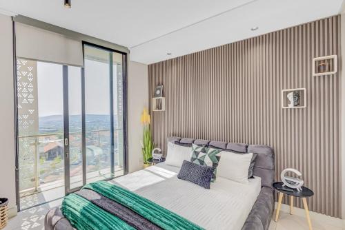 Postel nebo postele na pokoji v ubytování Aura Residence