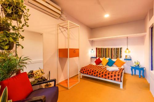 a room with a bed with colorful pillows at goSTOPS Lite Jaipur in Jaipur
