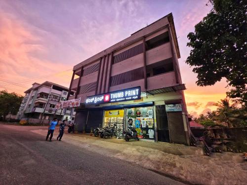 a man standing in front of a store on a street at The Urban Escape in Udupi