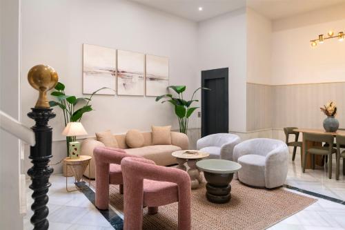 a living room with a couch and chairs and a table at Casa 1872, by Homing U in Seville