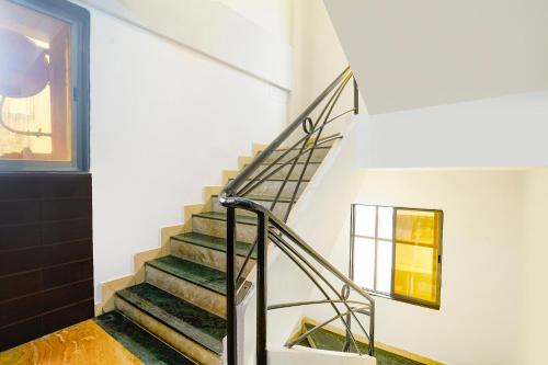 a staircase in a house with a window at FabHotel Wellax 24 Service Apartments in Navi Mumbai