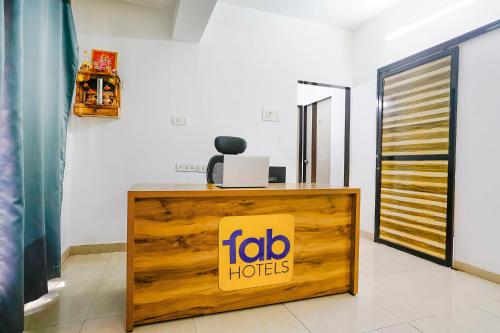 a reception desk with a ibo hotel sign on it at FabHotel Wellax 24 Service Apartments in Navi Mumbai