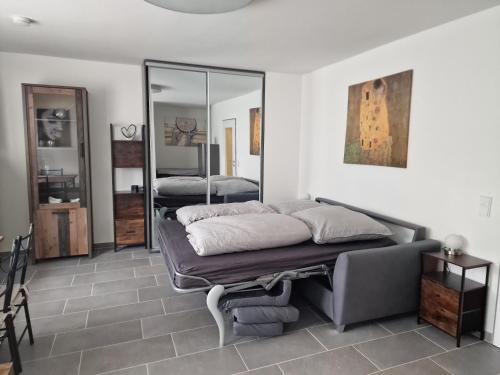 a bedroom with a bed and a mirror at Linda's Appartement in Bochum