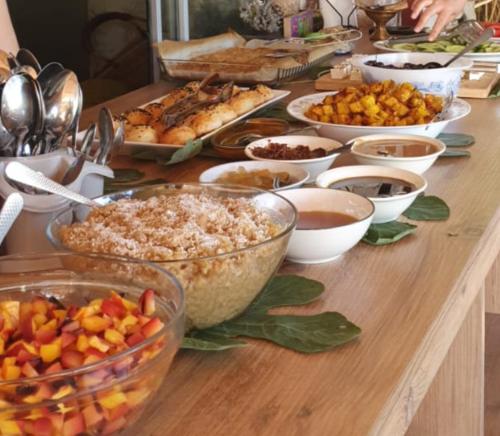 a table with many different types of food on it at Albatlos in Yaka