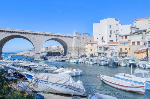 a group of boats in a harbor with a bridge at Le Cabanon du Vallon - Port des Auffes - Clim in Marseille