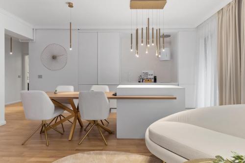 a kitchen and dining room with a table and chairs at Luxury Cosmopolit Apartments in the Heart of Brasov in Braşov