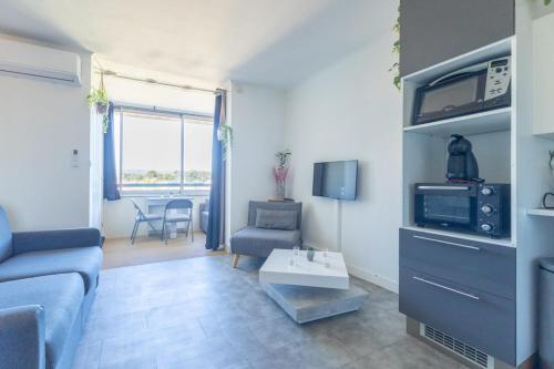 a living room with a couch and a table at La Baie des Anges - Plage à Pied - Garage Privé in La Ciotat
