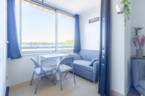a room with a table and chairs and a window at La Baie des Anges - Plage à Pied - Garage Privé in La Ciotat