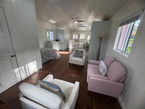 a living room with a couch and a chair at Tickled Pink in Harbour Island