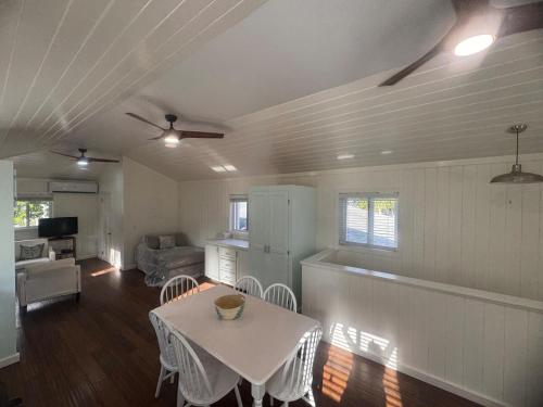 a living room with a table and a kitchen at Tickled Pink in Harbour Island