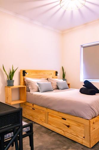 two beds in a room with white walls at S Haven Luxury Self Catering Apartment in Franskraalstrand