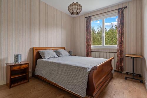 ein Schlafzimmer mit großem Bett und Fenster in der Unterkunft Chalet Echalas in Échalas