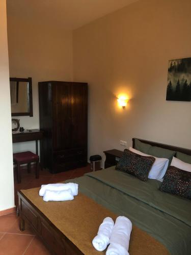 a bedroom with two beds and towels on a table at Panorama Elatis in Elati