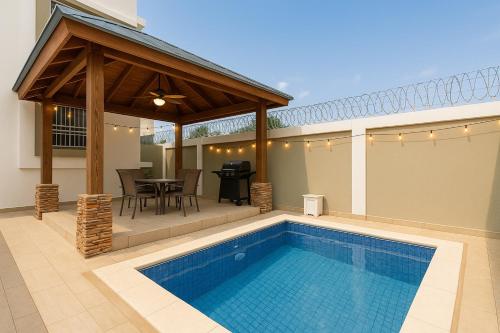 a patio with a swimming pool and a pavilion at Sky Blue in Jarabacoa