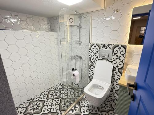 a bathroom with a toilet and a sink at Loft Cosy Stone House in Konak