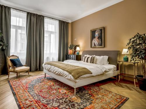 a bedroom with a large bed and a rug at Timeless Prague Apartment by House of Huxe in Golčŭv Jeníkov