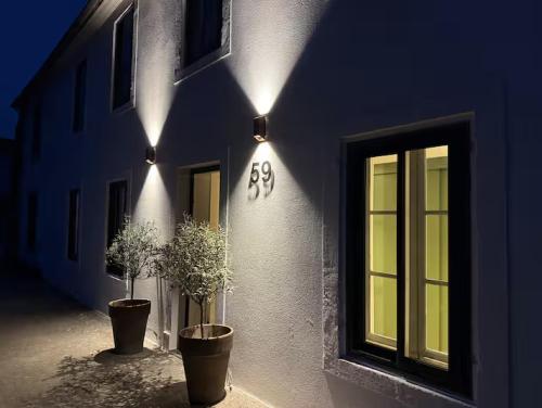 een gebouw met twee potplanten en lampen erop bij Le loft in Croix-Chapeau