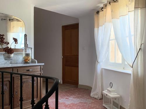 a room with a staircase and a window with curtains at Château Sainte BARBE in Loriol-du-Comtat