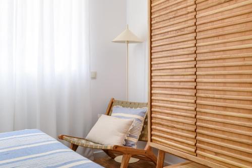 a bedroom with a wooden partition and a chair at Home on Rua da Alegria in Bicas