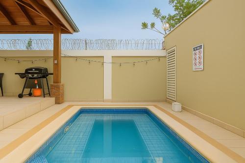 a swimming pool in the backyard of a house at Luxury Sky Blue in Jarabacoa