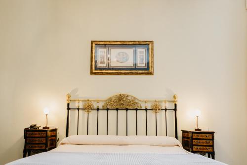a bedroom with a bed and a picture on the wall at Pazo Almuzara in Boborás
