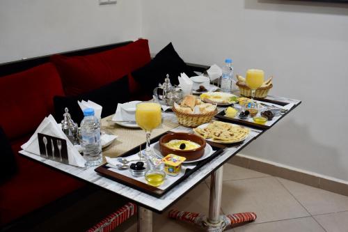 ダフラにあるRésidence Americaのテーブル(上に食べ物と飲み物付)