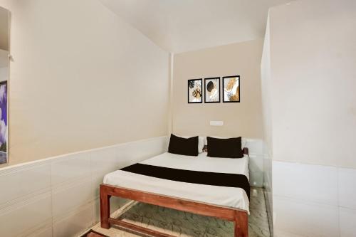 een klein bed in een kamer met witte muren bij Hotel O Arambol Beach Formerly Hakuna Matata in Arambol