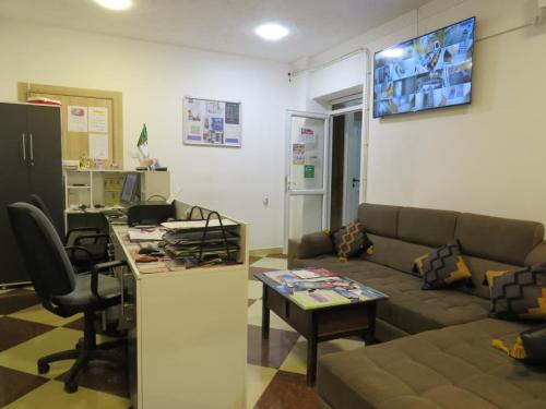 a living room with a couch and a table at OZ motel in Mechta el Hadj Douibi