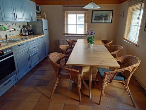 a kitchen with a wooden table and chairs at Ferienhaus Altes Elbschifferhaus in Königstein an der Elbe