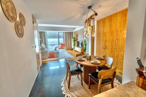 a dining room and living room with a table and chairs at Premium Vacation Home in Old Dubai Nr Metro Mall in Dubai