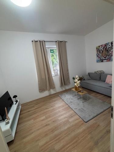 a living room with a couch and a window at Zentrales, neumodernes Apartmentment Püttquartier No 3 in Ibbenbüren