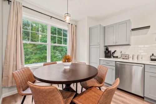 a kitchen with a table and chairs and a window at Spacious House with King Beds in Prime Location in Bloomfield