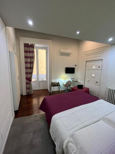 a large bedroom with a large bed and a living room at Donnalbina 7 The Fresh BB in Naples