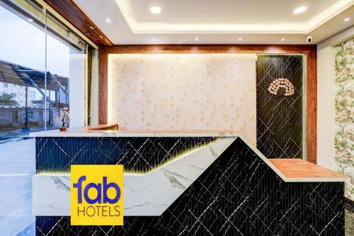 a lobby with a yellow sign in front of a counter at FabHotel Leon Square in Bengaluru