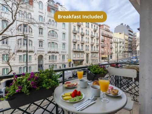 a table with food and drinks on a balcony at LX51 Lisbon Center - Studios & Suites by APT IIN in Lisbon