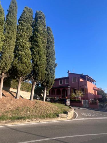 a house with trees on the side of a road at Belvedere House Peccioli in Peccioli