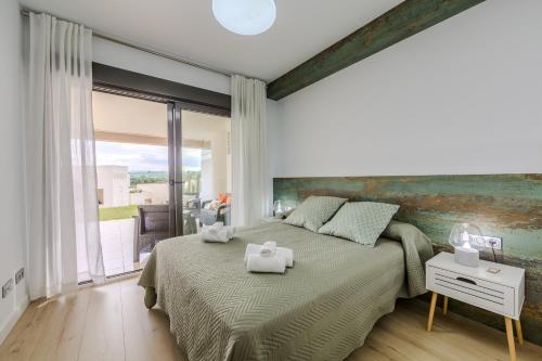 a bedroom with a large bed and a large window at AlmeriaSuite Vera Luxury Homes in Vera