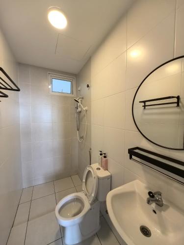a bathroom with a toilet and a sink and a mirror at Alor Setar Tower 3 Bedroom Suite Malay Only in Alor Setar