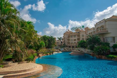 a bridge over a swimming pool at a resort at El Safwa Resort New Cairo in Cairo