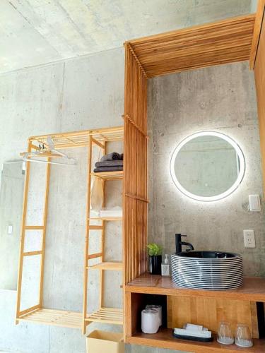 a room with a bunk bed and a sink at Stäy Hotel Nakijin in Nakijin