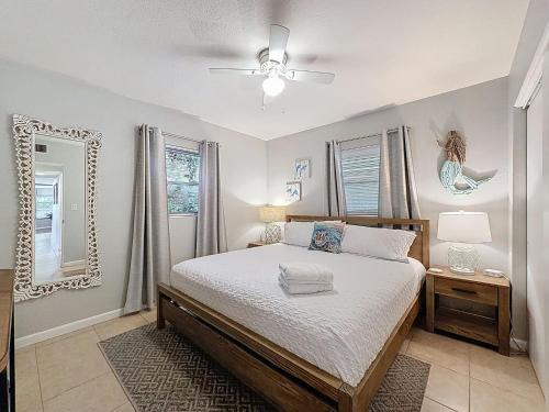 a bedroom with a bed and a ceiling fan at Largo Pool House Firepit Pet Friendly in Largo